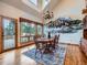 Elegant dining room with wood floors, mural wall art, and outdoor views offers a serene space at 7076 Boreas Rd, Larkspur, CO 80118