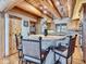 Cozy kitchen with wood beams, a breakfast bar, and natural wood cabinets presents rustic charm at 7076 Boreas Rd, Larkspur, CO 80118