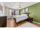 Comfortable bedroom featuring a large window, ceiling fan, and a neutral color palette at 320 S Ames St # 8, Lakewood, CO 80226