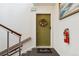 Apartment entrance with a welcome mat and an olive green door with floral wreath at 320 S Ames St # 8, Lakewood, CO 80226