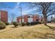 Well-maintained brick apartment building with green lawn and shrubbery at 320 S Ames St # 8, Lakewood, CO 80226