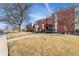 Brick apartment building featuring a red awning over the entrance and landscaping at 320 S Ames St # 8, Lakewood, CO 80226