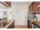 Kitchen view features granite countertops, wooden cabinets, and modern appliances at 320 S Ames St # 8, Lakewood, CO 80226