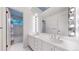 Bathroom with a double sink vanity, great lighting, and access to a separate shower and bathtub area at 4966 Delaware Dr, Larkspur, CO 80118