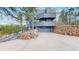 Modern exterior showcasing a gray home with a three-car garage and beautiful stonework at 4966 Delaware Dr, Larkspur, CO 80118
