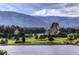 Scenic view of a golf course with rock formations and a mountain backdrop at 4966 Delaware Dr, Larkspur, CO 80118