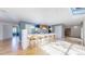 Bright kitchen area featuring a large island, barstool seating, and sleek modern finishes at 4966 Delaware Dr, Larkspur, CO 80118