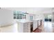 Stylish kitchen area featuring a large island, modern appliances, and ample natural light from the skylight at 4966 Delaware Dr, Larkspur, CO 80118