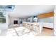 Open concept kitchen featuring a skylight, an island with seating and hardwood floors throughout at 4966 Delaware Dr, Larkspur, CO 80118