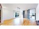 Open-concept living room featuring hardwood floors, modern lighting, and sliding glass doors to an outdoor deck at 4966 Delaware Dr, Larkspur, CO 80118