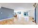 Spacious living area with wood floors, large sliding glass door, and access to the kitchen area at 4966 Delaware Dr, Larkspur, CO 80118