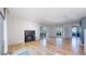 Cozy living area featuring a brick fireplace, wood floors and sliding glass doors to an outdoor deck at 4966 Delaware Dr, Larkspur, CO 80118