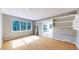 Bright living room with large windows overlooking lush greenery and built-in shelving for ample storage at 4966 Delaware Dr, Larkspur, CO 80118