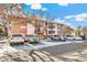 Exterior view of a condo building with parking and landscaping at 12132 Melody Dr # 104, Denver, CO 80234