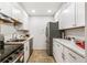 Bright kitchen with stainless steel appliances and white cabinets at 12132 Melody Dr # 104, Denver, CO 80234