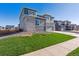 Two-story home with stone and siding, showcasing a well-manicured lawn at 1714 Marlowe W Cir, Erie, CO 80516