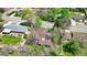 Aerial view of a single-Gathering house in a suburban neighborhood with mature trees and landscaping at 6463 Brentwood St, Arvada, CO 80004