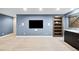 Finished basement media room with built-in shelving at 1636 Winona Ct, Denver, CO 80204