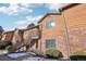 Condo building exterior showcasing brick and wood siding, with stairs leading to individual units at 2253 S Buckley Rd # 202, Aurora, CO 80013