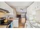 Kitchen with white cabinets, granite countertops, and a view into living area with fireplace at 2253 S Buckley Rd # 202, Aurora, CO 80013