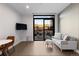 Open-concept area with a door to a balcony that offers outdoor dining, seating and neighborhood views at 1901 Wazee St # 312, Denver, CO 80202