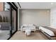 Relaxing bedroom with murphy bed, small sofa, and a sliding door opening to a patio with outdoor seating at 1901 Wazee St # 312, Denver, CO 80202