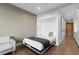 This room includes a cozy Murphy bed, small sitting area, and a view into the modern, bright kitchen at 1901 Wazee St # 312, Denver, CO 80202