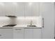 This modern kitchen is complete with stainless steel appliances, sleek white cabinets, and a bright white counter at 1901 Wazee St # 312, Denver, CO 80202