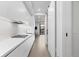 Modern kitchen featuring white cabinets, countertops and backsplash, stainless steel appliances and a sliding barn door at 1901 Wazee St # 312, Denver, CO 80202