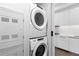 Modern laundry area with stacked washer and dryer adjacent to the kitchen at 1901 Wazee St # 312, Denver, CO 80202
