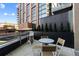 Relaxing outdoor patio with a table, chairs, and beautiful plantings at 1901 Wazee St # 312, Denver, CO 80202