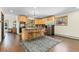 Bright kitchen with wood cabinets, an island with seating, and stainless-steel appliances at 13035 S Baird Rd, Conifer, CO 80433