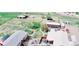 Expansive aerial view of a charming home with a pool, horse enclosures, and a serene rural setting at 16659 County Road 4, Brighton, CO 80603