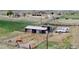 Aerial view featuring the barn and corrals with horses in the pasture at 16659 County Road 4, Brighton, CO 80603