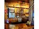 Unique wooden bar with rustic decor, lighting, and a built-in drink refrigerator at 16659 County Road 4, Brighton, CO 80603