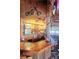 Custom wooden bar with liquor display, seating, and unique rustic decor at 16659 County Road 4, Brighton, CO 80603