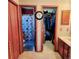 Bright bathroom featuring a shower with decorative curtain and next to closet for storage at 16659 County Road 4, Brighton, CO 80603