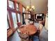 Open-concept dining room with a chandelier, hardwood table, and abundant natural light at 16659 County Road 4, Brighton, CO 80603