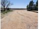 Long gravel driveway leading to open space with mature trees and distant mountain views at 16659 County Road 4, Brighton, CO 80603