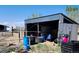 Exterior shot of an open shed and an old horse trailer, creating a rural scene at 16659 County Road 4, Brighton, CO 80603