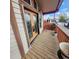 Welcoming front porch with a decorative glass door, a wooden deck, and plenty of space for seating at 16659 County Road 4, Brighton, CO 80603