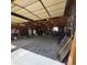 Well-lit garage featuring ample storage, exposed beam ceiling, and equipment, perfect for hobbies or professional use at 16659 County Road 4, Brighton, CO 80603