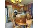 Charming kitchen with wooden cabinets, an island, and an adjacent dining area with a round table at 16659 County Road 4, Brighton, CO 80603