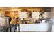 Kitchenette features stainless appliances, ample counter space, and rustic wood walls at 16659 County Road 4, Brighton, CO 80603