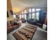Spacious living room with vaulted ceilings, multiple seating areas, and large windows at 16659 County Road 4, Brighton, CO 80603