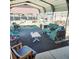 Dog rests on the sofa in the covered outdoor living space at 16659 County Road 4, Brighton, CO 80603