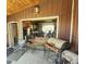 Covered outdoor patio area with seating and a grill, leading to a living area at 16659 County Road 4, Brighton, CO 80603