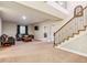 This basement features a staircase, carpet, sofas, and a television at 24608 E Moraine Pl, Aurora, CO 80016