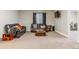 This basement features carpet, sofas, a television, and a window at 24608 E Moraine Pl, Aurora, CO 80016