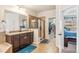 This bathroom features a shower, double vanity, large mirror, and walk-in closet at 24608 E Moraine Pl, Aurora, CO 80016